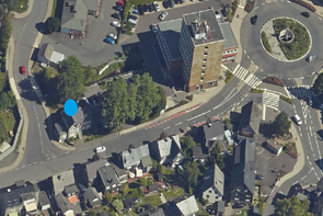 Luftbildaufnahme von Siegen-Eiserfeld, inklusive Markierung des Verkaufsobjekts in der Siegtalstraße 10, Kreisverkehr und umliegender Bebauung.