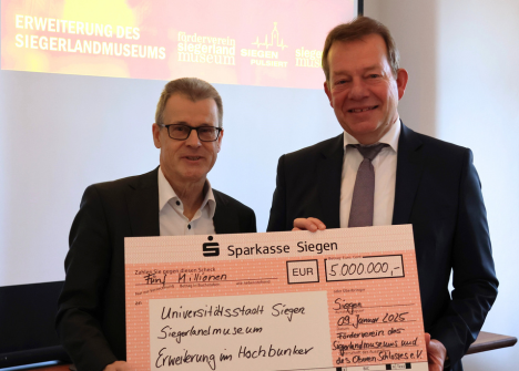 Übergabe eines symbolischen Schecks über 5 Millionen Euro für die Erweiterung des Siegerlandmuseums durch Günter Zimmermann (links) an Bürgermeister Steffen Mues (Foto: Stadt Siegen)